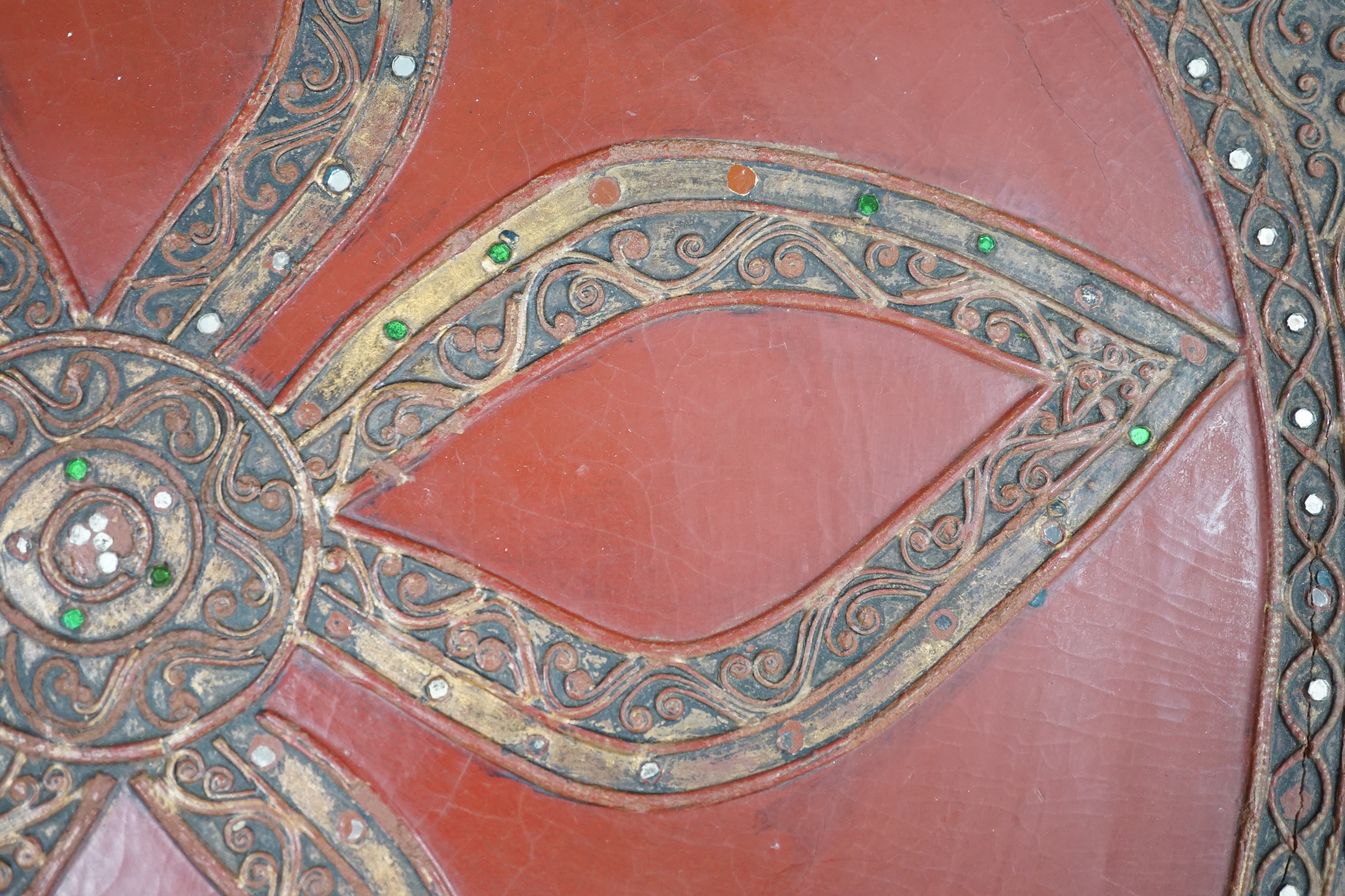 A South East Asian composition red lacquered table inset mirrored sequins, 44cm high x 51cm in diameter
